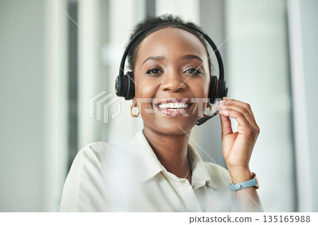Black woman face, call center and phone consultation with a smile in a office with contact us work. Telemarketing, portrait and African female employee with communication and customer service Black woman face, call center and phone consultation with a smile in a office with contact us work. Telemarketing, portrait and African female employee with communication and customer service 135165988