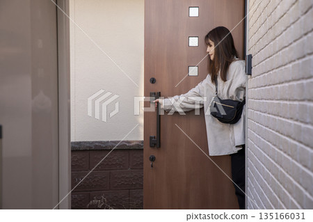 Woman leaving the front door 135166031