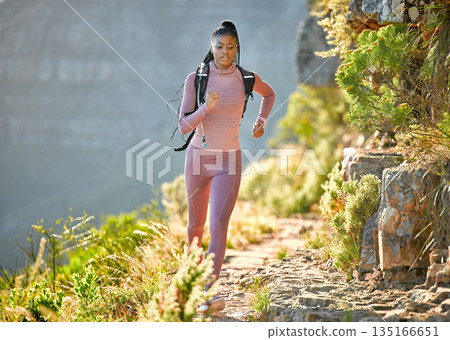 Black woman, mountain running and outdoor for fitness, speed or challenge for wellness with focus in summer. African girl, workout and runner training in sunshine with exercise, adventure and hiking Black woman, mountain running and outdoor for fitness, speed or challenge for wellness with focus in summer. African girl, workout and runner training in sunshine with exercise, adventure and hiking 135166651