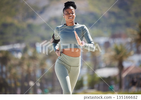 Fitness, running outdoor and black woman with earphones for music, podcast or radio. Exercise, cardio and African female runner listening to audio, sound and song for workout, training and sports. 135166682