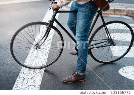 Bicycle, travel and legs of business man on street for transport, commute and journey to work. City, traffic and male person on bike for eco friendly, carbon neutral and sustainability transportation Bicycle, travel and legs of business man on street for transport, commute and journey to work. City, traffic and male person on bike for eco friendly, carbon neutral and sustainability transportation 135166771