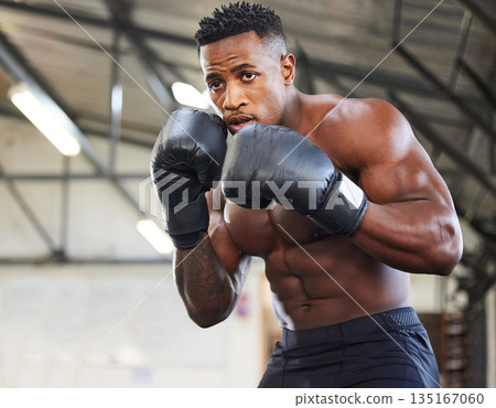 African man, boxing and punch in gym for fitness, focus or training for growth, goal and wellness for competition. African guy, boxer and gloves for exercise, wellness or martial arts club for sports 135167060