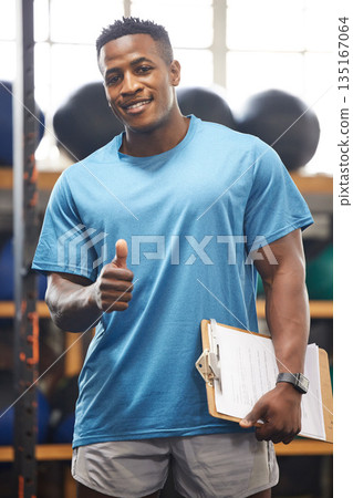 Thumbs up, portrait and fitness man in gym, clipboard and checklist for workout results, progress and like, yes or okay hand. African person, athlete or bodybuilder paperwork and thank you sign Thumbs up, portrait and fitness man in gym, clipboard and checklist for workout results, progress and like, yes or okay hand. African person, athlete or bodybuilder paperwork and thank you sign 135167064