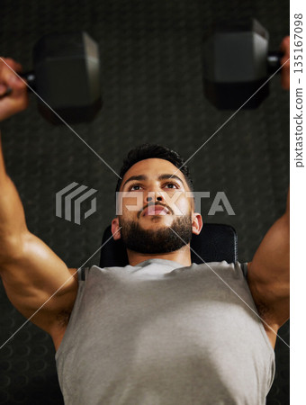 Bench press, workout and man with weight in gym for fitness, bodybuilder training and exercise. Sports, strong muscle and serious male person lifting weight for wellness, healthy body and strength Bench press, workout and man with weight in gym for fitness, bodybuilder training and exercise. Sports, strong muscle and serious male person lifting weight for wellness, healthy body and strength 135167098