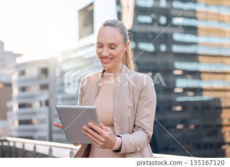 Smile, businesswoman with tablet and happy in city background outdoors. Social media or connectivity, online communication and networking with female person writing an email on rooftop of building 135167120