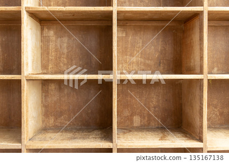 A storage shelf with an appealing texture of used wood A storage shelf with an appealing texture of used wood 135167138