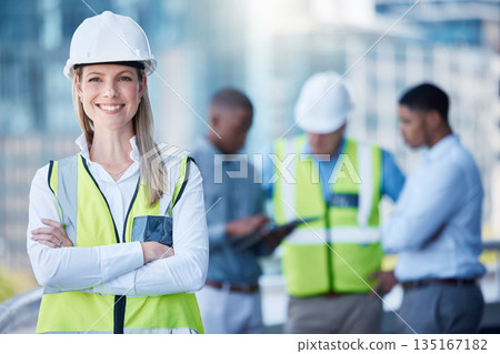 Portrait, arms crossed and a woman construction worker outdoor on a building site with her team in the background. Management, leadership and confidence with a female architect standing outside Portrait, arms crossed and a woman construction worker outdoor on a building site with her team in the background. Management, leadership and confidence with a female architect standing outside 135167182