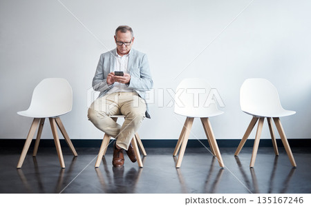 Phone, hiring and business man in waiting room for job interview, networking and recruitment. Mobile, internet and technology on chair with senior male employee for career, contact or hr consultation 135167246