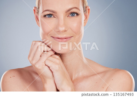 Beauty, makeup and portrait of woman in studio for facial, cosmetics and natural skincare. Self care, wellness and mockup with face of female model on grey background for glow, happiness and collagen 135167493