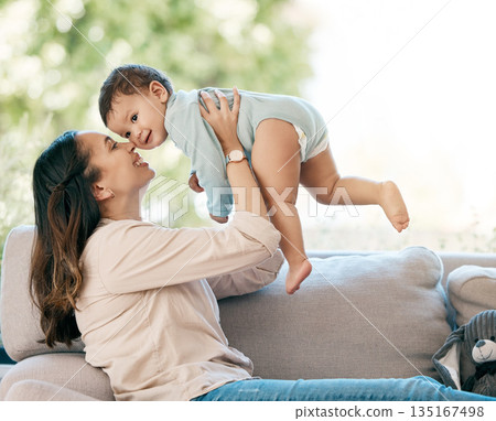 Love, airplane and mother with baby on a sofa for games, playing and laughing in their home together. Family, smile and mom with girl toddler on a couch, relax and flying, fun and hug in living room Love, airplane and mother with baby on a sofa for games, playing and laughing in their home together. Family, smile and mom with girl toddler on a couch, relax and flying, fun and hug in living room 135167498