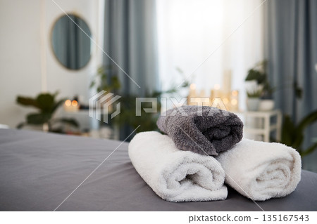 Towel, bed and spa background for wellness, luxury and health industry with candle bokeh for calm or peace. Massage, hotel and room for holiday or vacation, interior design and hospitality services Towel, bed and spa background for wellness, luxury and health industry with candle bokeh for calm or peace. Massage, hotel and room for holiday or vacation, interior design and hospitality services 135167543