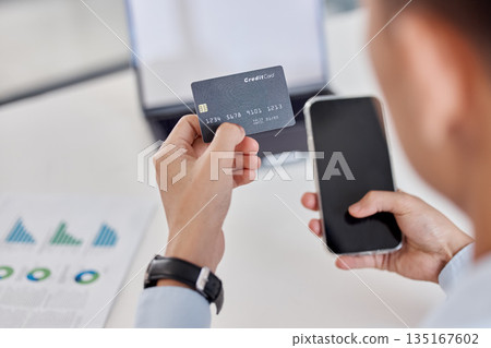Businessman, hands and phone with credit card for online shopping, banking or finance at office. Hand of man employee or shopper with debit and smartphone for bank payment or ecommerce at workplace 135167602