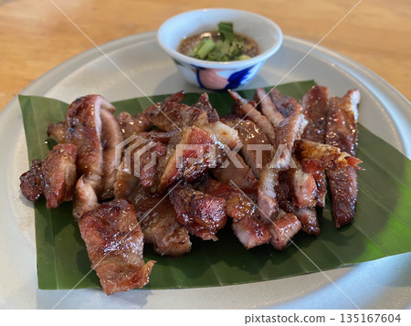 Thailand street food, grilled pork neck with Thai dipping sauce, close-up shot blurred background, no people. 135167604