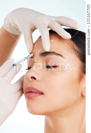 Skincare, woman and face syringe for plastic surgery in studio isolated on white background. Facial, injection and cosmetics of female model with collagen filler for dermatology, beauty or aesthetic. Skincare, woman and face syringe for plastic surgery in studio isolated on white background. Facial, injection and cosmetics of female model with collagen filler for dermatology, beauty or aesthetic. 135167705