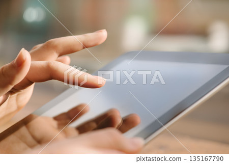 Woman, hands and working on tablet, screen and technology for typing online in a cafe with app, network or social media. Hand, touchscreen and reading news, blog or search on internet website Woman, hands and working on tablet, screen and technology for typing online in a cafe with app, network or social media. Hand, touchscreen and reading news, blog or search on internet website 135167790