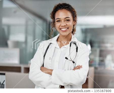 Healthcare, portrait of woman doctor with arms crossed and with stethoscope in a hospital building happy with a lens flare. Medical, wellness and female surgeon or nurse smile excited in a clinic 135167800
