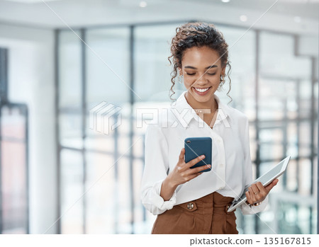Business, woman and reading on mobile phone with tablet at the office with a smile for online communication. Female professional, technology and typing at a company for conversation on the internet. Business, woman and reading on mobile phone with tablet at the office with a smile for online communication. Female professional, technology and typing at a company for conversation on the internet. 135167815