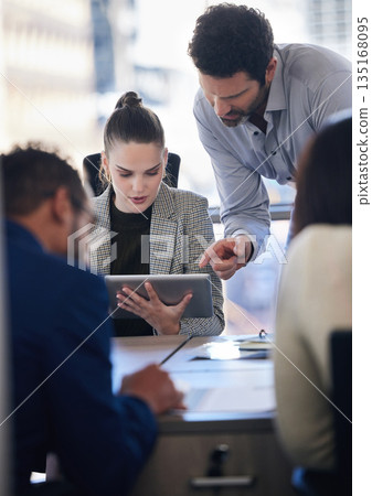 Digital tablet, collaboration and team doing research together in a meeting in the office. Technology, professional and business people working on a corporate project in the workplace boardroom. Digital tablet, collaboration and team doing research together in a meeting in the office. Technology, professional and business people working on a corporate project in the workplace boardroom. 135168095
