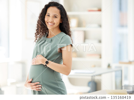 Portrait, smile and a pregnant business woman in her office getting ready for maternity leave from work. Happy, mother and proud with a young female employee holding her stomach in the workplace Portrait, smile and a pregnant business woman in her office getting ready for maternity leave from work. Happy, mother and proud with a young female employee holding her stomach in the workplace 135168419