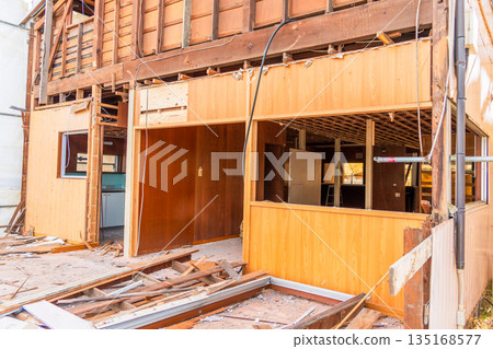 Demolition site of an old wooden house 135168577