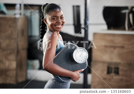 Gym, portrait or happy black woman with scale after body training or fitness workout to lose weight. Wellness, personal trainer or African girl athlete in health club for exercising progress results 135168603