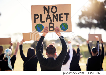 Protest, climate change and sign with a group of people outdoor at a rally or march for conservation. Global warming, poster and environment with a crowd walking together during a community strike 135168613