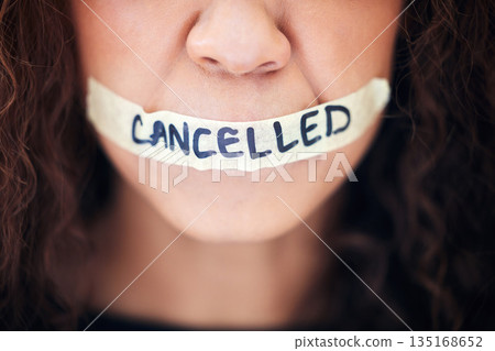 Political, protest and closeup with tape on a mouth for justice, freedom or revolution movement. Bullying, violence and zoom of a woman with cancelled on lips for feminism, activism or discrimination Political, protest and closeup with tape on a mouth for justice, freedom or revolution movement. Bullying, violence and zoom of a woman with cancelled on lips for feminism, activism or discrimination 135168652