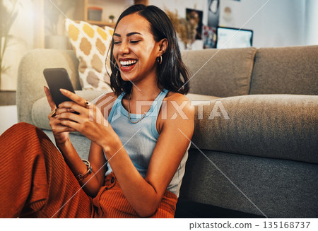 Woman laughing at chat on smartphone, social media and funny meme with communication and technology. Female person relax at home, using phone and comedy online with streaming and texting on app Woman laughing at chat on smartphone, social media and funny meme with communication and technology. Female person relax at home, using phone and comedy online with streaming and texting on app 135168737