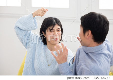 A wife attacks her husband and the husband is frightened A wife attacks her husband and the husband is frightened 135168742