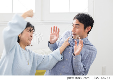 A wife attacks her husband and the husband is frightened A wife attacks her husband and the husband is frightened 135168744