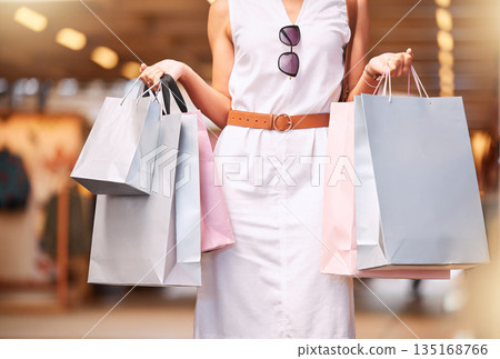 Fashion, mall and woman with shopping bag in hands for a sale or discount deal. Female person or customer advertising retail bags for promotion offer, luxury designer product and store credit or gift Fashion, mall and woman with shopping bag in hands for a sale or discount deal. Female person or customer advertising retail bags for promotion offer, luxury designer product and store credit or gift 135168766