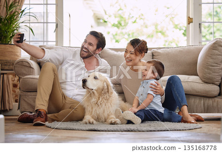 Selfie, social media and happy family in the living room with a dog for internet. Smile, playing and parents, baby and a pet taking a photo for the web, chat or profile picture on the house floor Selfie, social media and happy family in the living room with a dog for internet. Smile, playing and parents, baby and a pet taking a photo for the web, chat or profile picture on the house floor 135168778