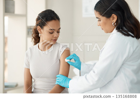 Healthcare, cotton and arm for vaccine at the hospital for safety or cure for virus or disease. Doctor, clinic and patient before vaccination for consultation with gloves for medical care and help. Healthcare, cotton and arm for vaccine at the hospital for safety or cure for virus or disease. Doctor, clinic and patient before vaccination for consultation with gloves for medical care and help. 135168808