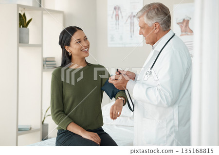 Senior doctor, blood pressure and patient in a consultation, healthcare and appointment with treatment, diagnosis and results. Wellness check, woman or medical professional with cuff for hypertension 135168815