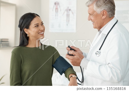 Senior doctor, blood pressure or patient in a consultation, wellness or appointment with results, checkup or talking. Healthcare, woman or medical physician with cuff for hypertension or examination Senior doctor, blood pressure or patient in a consultation, wellness or appointment with results, checkup or talking. Healthcare, woman or medical physician with cuff for hypertension or examination 135168816