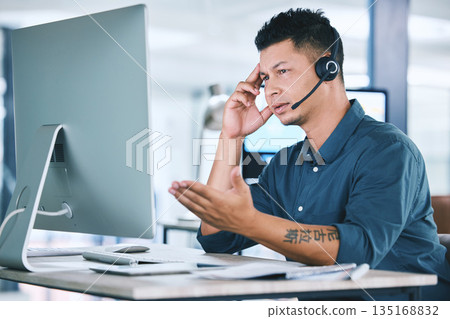 Mental health, businessman with stress and with headset at his computer in his workplace office at a desk. Telemarketing or call center, problem and problem with a male person at his workstation Mental health, businessman with stress and with headset at his computer in his workplace office at a desk. Telemarketing or call center, problem and problem with a male person at his workstation 135168832