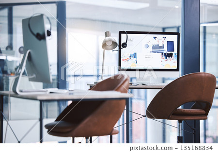 Internet, call center and headset on a computer screen in an empty office space for customer service. Crm, telemarketing and sales or technical support company with contact us website on a desktop 135168834