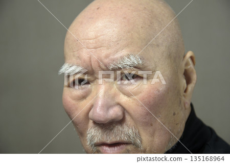 Close-up of an elderly man's troubled face 135168964