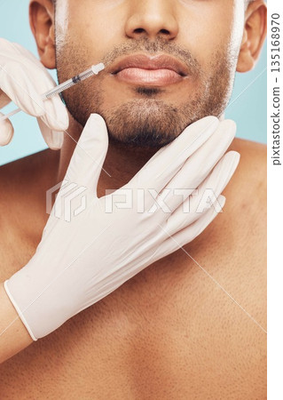 Skincare, botox and lips with a man in studio on a gray background for a plastic surgery injection. Hands, beauty and syringe with a young male patient indoor for an antiaging facial filler closeup Skincare, botox and lips with a man in studio on a gray background for a plastic surgery injection. Hands, beauty and syringe with a young male patient indoor for an antiaging facial filler closeup 135168970