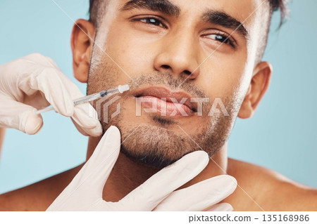 Beauty, botox and mouth with a man in studio on a gray background for a plastic surgery injection. Hands, skincare and syringe with a young male patient indoor for an antiaging facial filler closeup 135168986