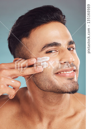Portrait, skin care and cream with a man in studio on a gray background to apply antiaging face treatment. Facial, beauty or lotion with a young male person indoor for wellness or aesthetic self care Portrait, skin care and cream with a man in studio on a gray background to apply antiaging face treatment. Facial, beauty or lotion with a young male person indoor for wellness or aesthetic self care 135168989