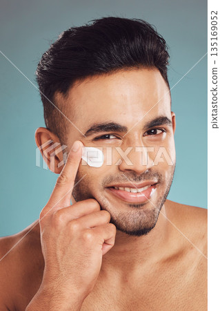Portrait, skincare and lotion with a man in studio on a gray background to apply antiaging facial treatment. Face, beauty and cream with a young male person indoor for wellness or aesthetic self care Portrait, skincare and lotion with a man in studio on a gray background to apply antiaging facial treatment. Face, beauty and cream with a young male person indoor for wellness or aesthetic self care 135169052