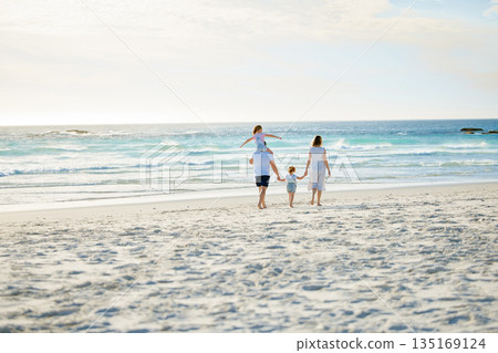 Happy, holding hands and travel with family at beach for summer, vacation and bonding. Freedom, support and ocean with parents and children walking on seaside holiday for love, care and happiness 135169124