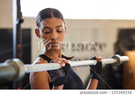 Fitness, Indian woman or bodybuilder with a barbell in training, workout or exercise for body building. Girl, mindset or healthy athlete weightlifting powerlifting with focus at gym club studio Fitness, Indian woman or bodybuilder with a barbell in training, workout or exercise for body building. Girl, mindset or healthy athlete weightlifting powerlifting with focus at gym club studio 135169158