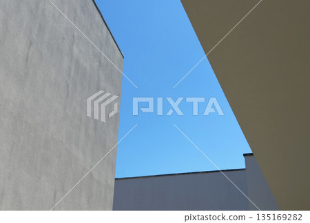 Architecture with modern geometric design. Contemporary building exterior with concrete texture, Architecture with modern geometric design. Contemporary building exterior with concrete texture, 135169282