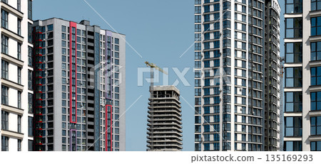 Building in urban city landscape. Modern skyscraper architecture with tall highrise blocks, dense 135169293