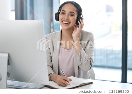 Headphones, happy and portrait of business woman with smile listening to radio, song and audio in office. Corporate workplace, music and face of female worker writing notes, planning and schedule Headphones, happy and portrait of business woman with smile listening to radio, song and audio in office. Corporate workplace, music and face of female worker writing notes, planning and schedule 135169300