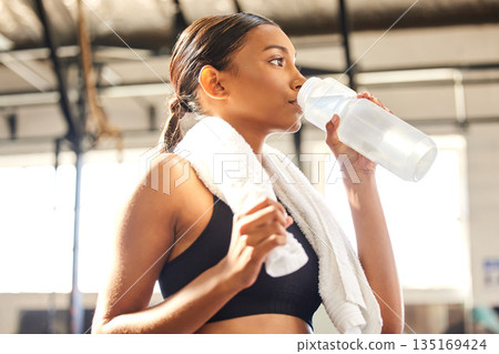 Relax, fitness or Indian woman drinking water in gym after training, workout or exercise to hydrate her body. Fatigue, wellness or tired girl with bottle for healthy liquid hydration on resting break Relax, fitness or Indian woman drinking water in gym after training, workout or exercise to hydrate her body. Fatigue, wellness or tired girl with bottle for healthy liquid hydration on resting break 135169424