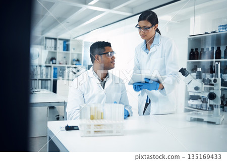 Scientists, tablet and teamwork in research at lab for science data, discovery or results. Man and woman medical professional team working with technology for scientific experiment in the laboratory Scientists, tablet and teamwork in research at lab for science data, discovery or results. Man and woman medical professional team working with technology for scientific experiment in the laboratory 135169433