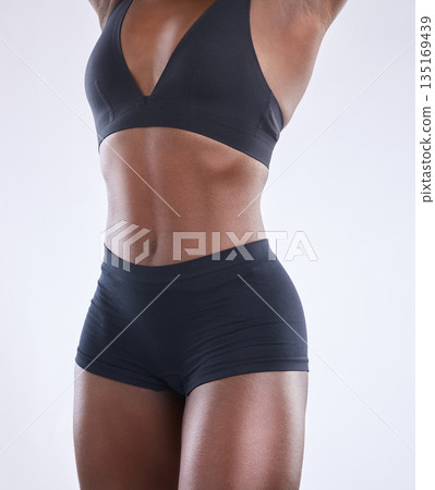 Stomach, fitness and health with black woman in studio for nutrition, weight loss and diet. Beauty, wellness and body muscle with closeup of female model on white background for self care and glow 135169439